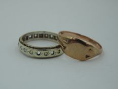 A yellow metal eternity ring stamped 9ct having cubic zirconia stones (af) and a rose gold signet