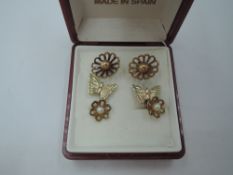 Three pairs of 9ct gold and yellow metal stud earrings of various forms, approx 3g