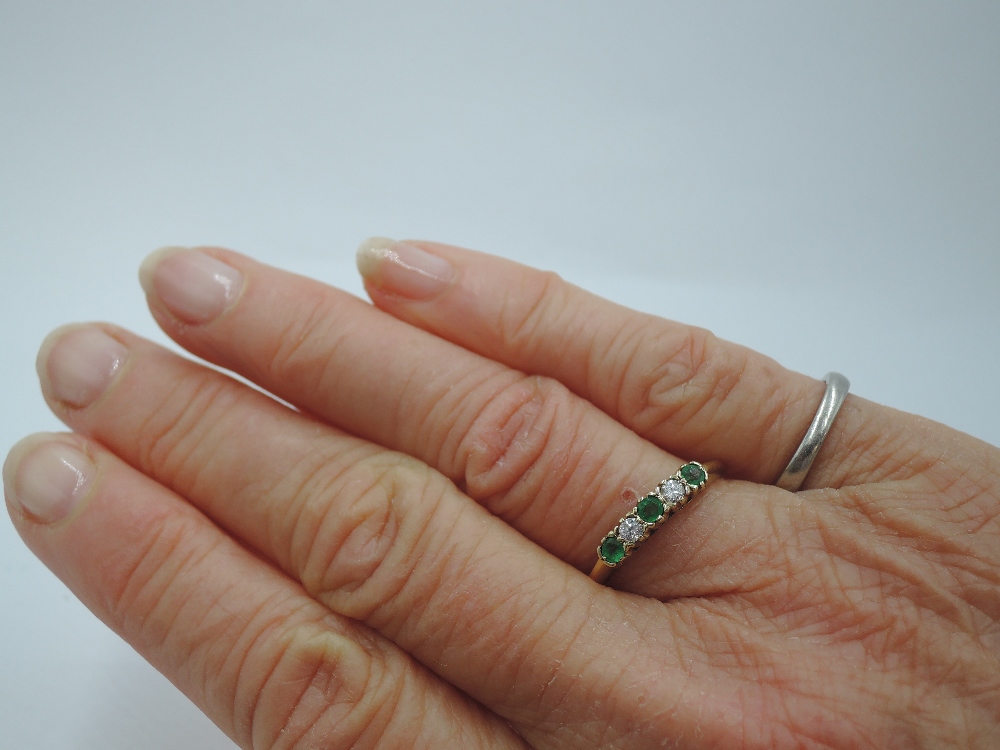 A five stone diamond and emerald dress ring having three emeralds interspersed by two diamonds in - Image 2 of 2