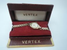 A lady's vintage 9ct gold wrist watch by Vertex having an Arabic numeral dial to circular face in