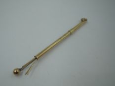 A yellow metal cocktail swizzle stick bearing monogram P.S to side, no marks, tested as 9ct gold,