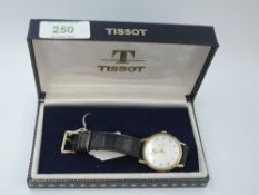 A gent's 1960's 9ct gold wrist watch by Tissot having gilt Arabic numeral dial to frosted face