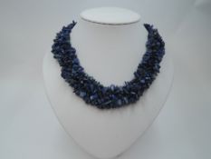 A woven multi strand rough cut lapis lazuli necklace of collarette style