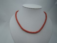 A string of coral beads of cylindrical form, no clasp, approx 22'