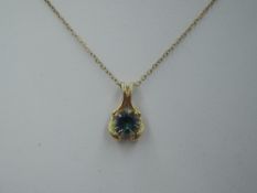 A crystal pendant in a 9ct gold tear drop mount on a yellow metal chain stamped 9ct, approx 24' &