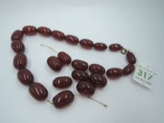 A short string of graduated cherry amber beads of oval form, (AF) approx 16' & 39.4g