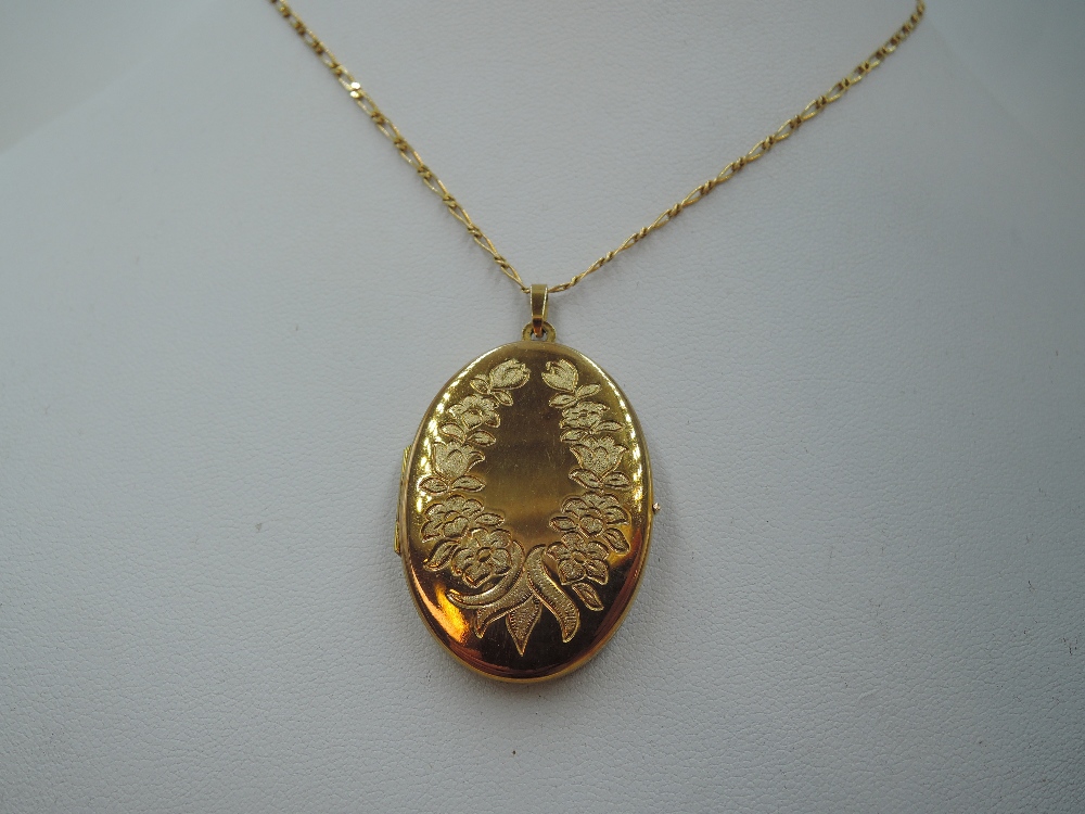 A 9ct gold oval locket having engraved floral decoration to front, on a 9ct gold figaro chain, - Image 2 of 2