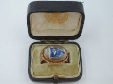 A Victorian 18ct gold cravat ring of oval form having a crystal cabouchon depicting the Burgee for