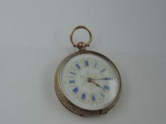 A small continental yellow metal key wound pocket watch stamped 9K having blue enamel and gilt Roman