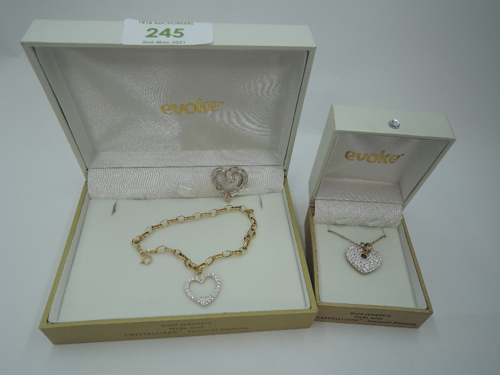 A cased Evoke Gold n Ice 9ct gold bracelet with crystal set heart charm, a matching Gold n Ice