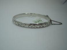 A silver hinged bangle having engraved scroll decoration, Chester 1956, Charles Horner, approx 14g