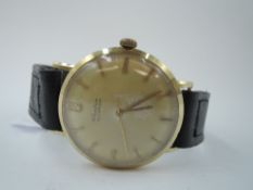 A gent's 14ct gold automatic wrist watch by Kiefer having a baton numeral dial with sweeping