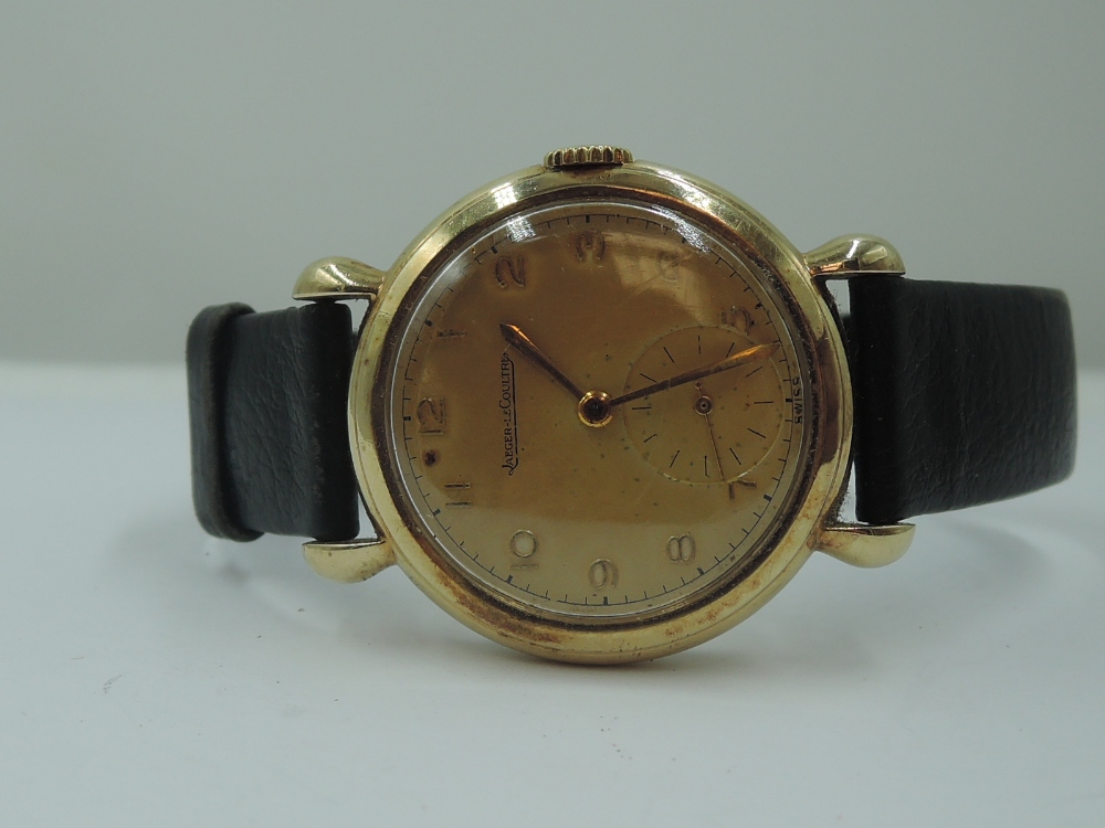 A gent's 1950's 9ct gold wrist watch by Jaeger Le Coultre no:799107 having Arabic numeral dial