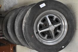 A set of Rostyle wheels with tyres, suitable for MGB and early Datsun vehicles.