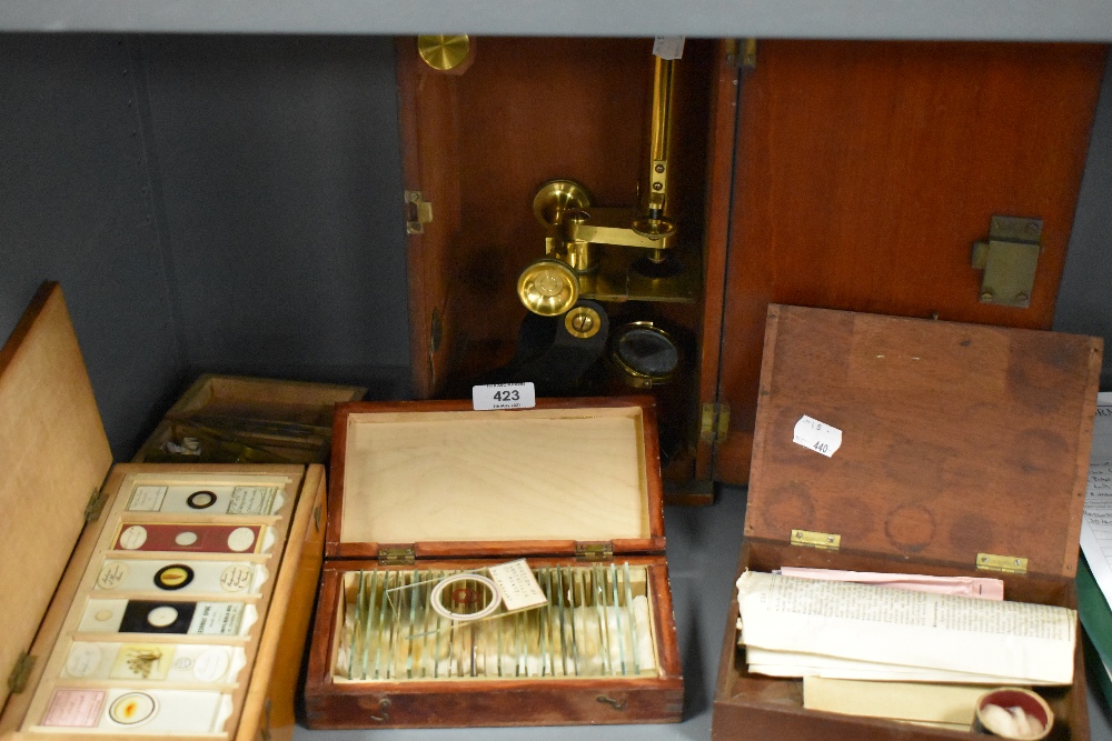 A fine selection of antique scientific microscopes and labeled slide sets natural history related