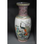 A large standing Cantonese styled floor vase having peacock enamel scene and standing at 60cm tall