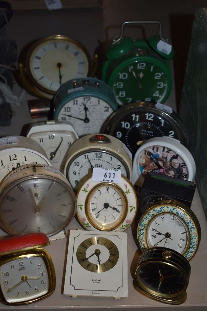 Fifteen vintage and retro alarm clocks, various colours, styles and eras.