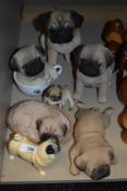 Seven pug dog figurines.