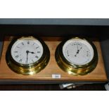 A ships style barometer and clock with porthole design