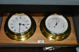 A ships style barometer and clock with porthole design