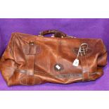 A vintage leather duffel or sports bag bearing label Topeu