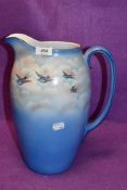 A large ceramic water jug by Palissy having Swift and sky design