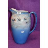 A large ceramic water jug by Palissy having Swift and sky design