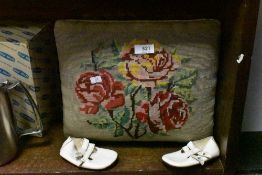 A traditional oak foot stool having embroidered top and a pair of childs white leather shoes