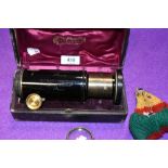 An antique cased brass bodied lens Extension No. 103525 Tele Objectif Panorthoscopeique in great