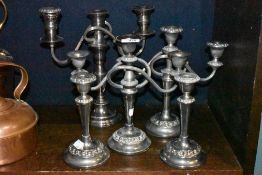 A selection of silver plated candle sticks stems and candelabra