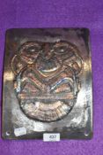 A heavy set metal plaque welded in the shape of an owl