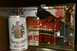 A reproduction advertising mirror for Coca Cola and similar advertising mug