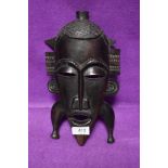 An African hand carved tribal mask in ethnic wood