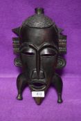 An African hand carved tribal mask in ethnic wood