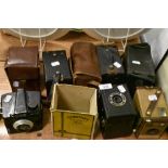 A collection of vintage cameras including Ilford Envoy, Coronet box camera, Kodak Brownie and more.