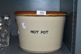 A large ceramic crock pot stamped hot pot