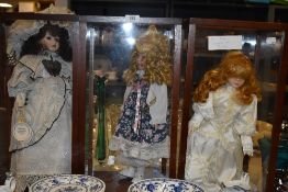 Three cased display dolls.