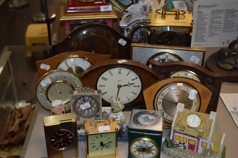 A mixture of clocks including vintage wooden examples and more.