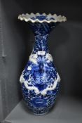A large standing blue and white wear Chinese vase having raised dragon motif and scalloped rim