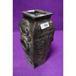 A bronze cast Chinese vase having archaic twin handle design 22cm high base plate having been