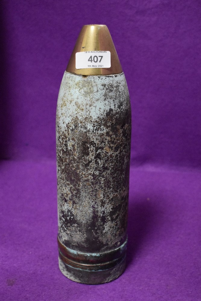 A military artillary shell having worn patina and 30cm high having been drilled for lamp