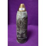 A military artillary shell having worn patina and 30cm high having been drilled for lamp