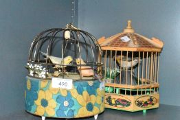 A mid century automaton of a bird cage and a similar wooden bodied example