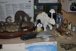 A selection of animal related figurines including a wooden set of stackable animals.