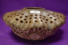 An unusual piece of studio art pottery having earthen ware body and naturalistic design most