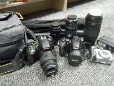 A selection of cameras, lenses and equipment including Nikon D3300 and Nikon Coolpix, a Nikkor AF-