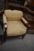 A Victorian mahogany spindle back easy armchair having later lemon upholstery