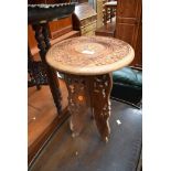 An Eastern carved occasional table