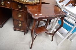 A mahogany hall way wash stand having curved frame work and shelf