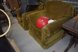 A pair of large lounge armchairs, in gold upholstery